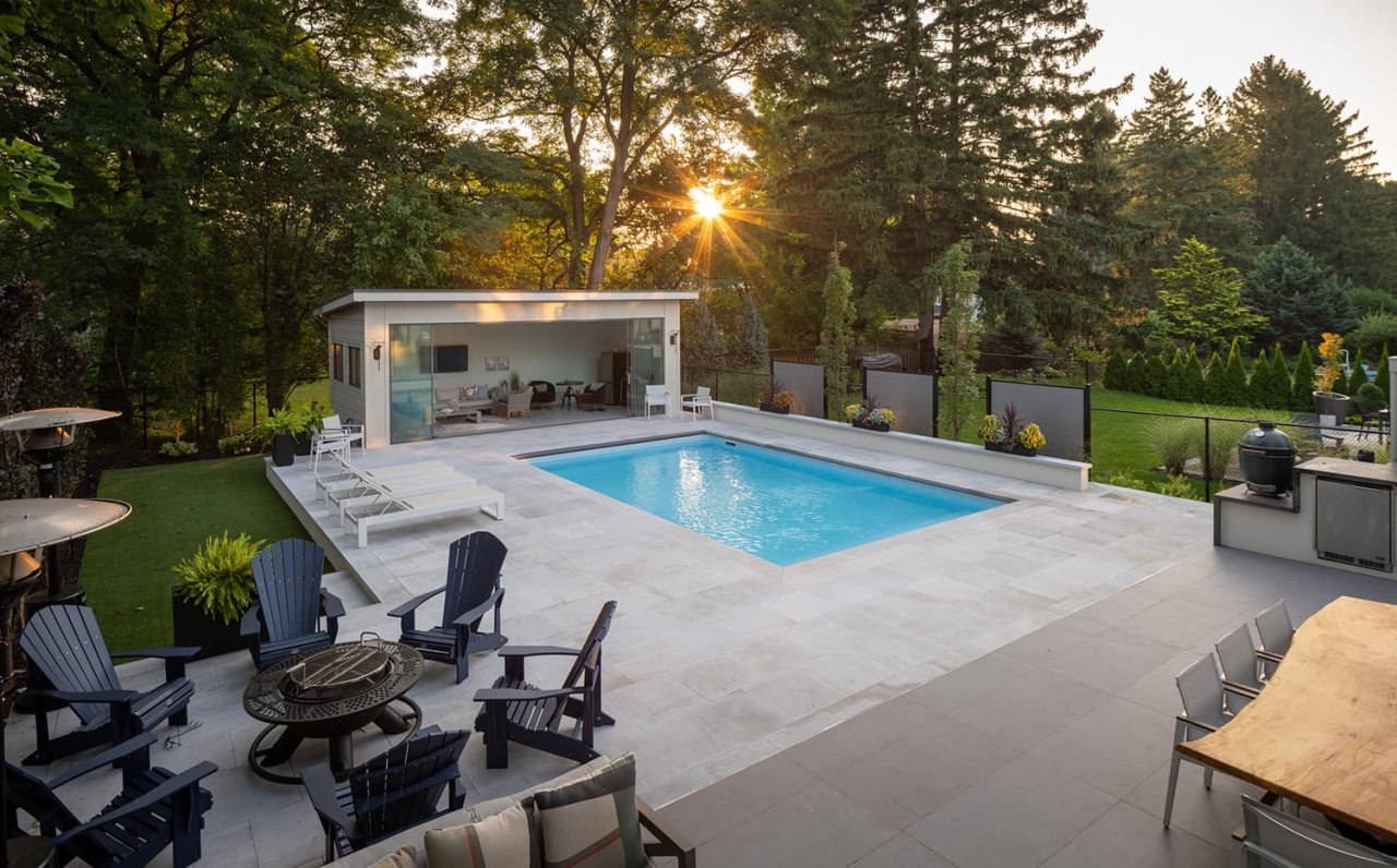 Backyard pool with shed and fireplace.